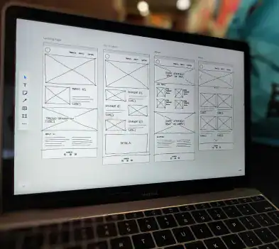 A laptop displaying a sketch of a web page, representing the requirements gathering phase for a project at Whale Coast Web.